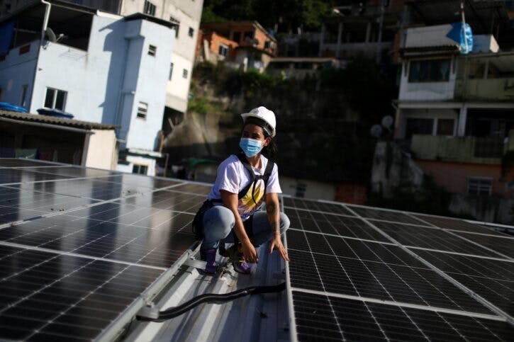 Solar panels are seen on the roof of the favela residents’ association headquarters in the Babilonia favela in Rio de Janeiro