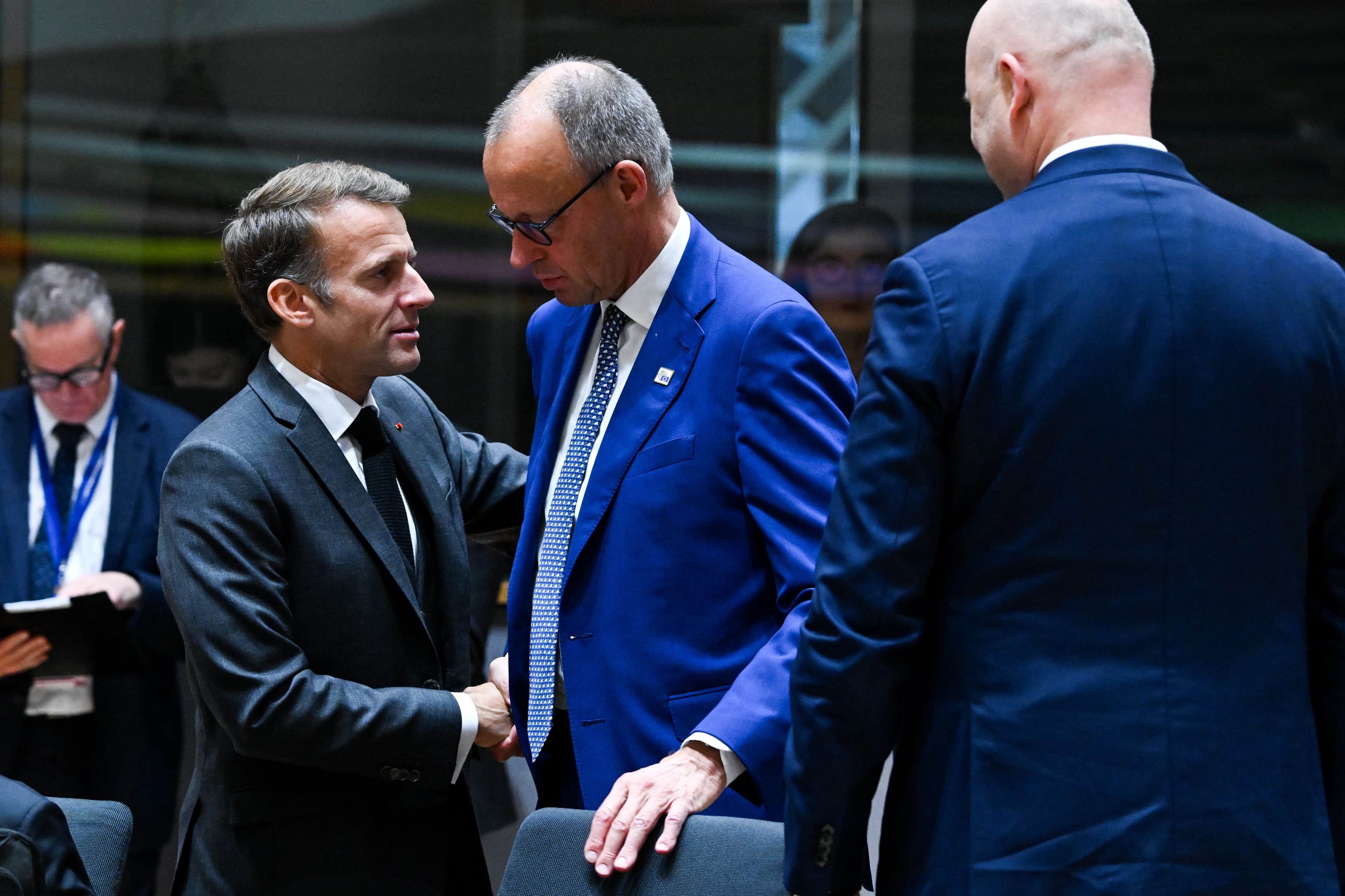 French President Emmanuel Macron speaks with German CDU leader Friedrich Merz.